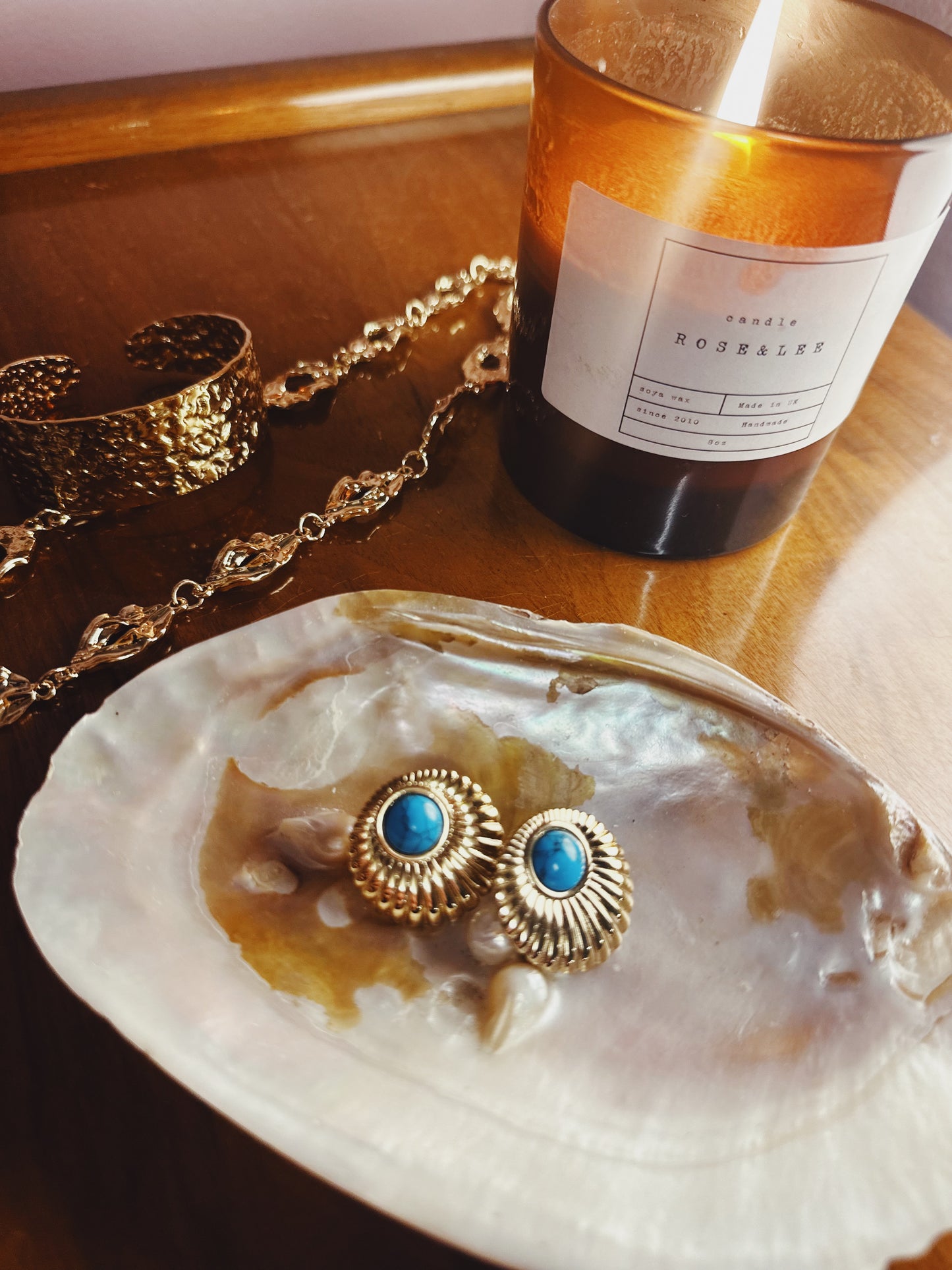 Vintage-inspired gold earrings with blue stone centre