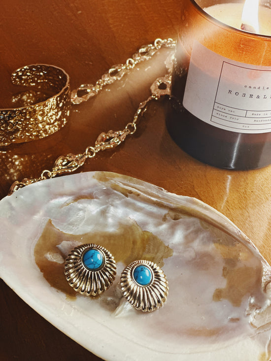 Vintage-inspired gold earrings with blue stone centre